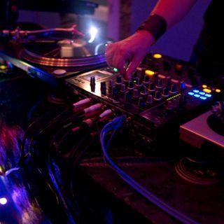 DJ Decks with a hand playing on the mixer