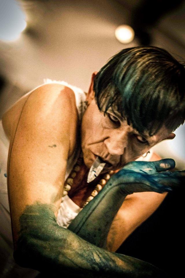 Performer Ana Wojak with painted arms and makeup