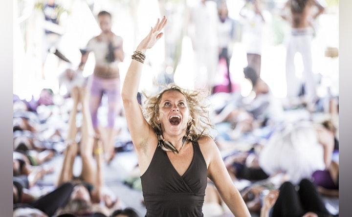 Woman undertaking breathwork workshop looking relieved