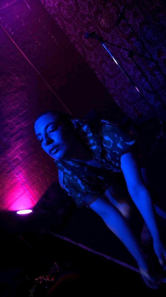 performer algal__bloom on stage in dark lighting