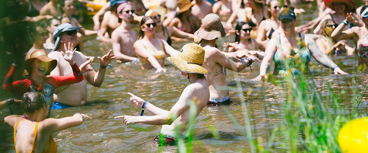 Jungle Love Festival patrons participating in a workshop in the creek